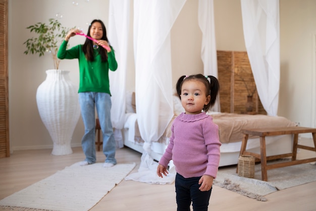 Little asian girl spending time at home with her mother