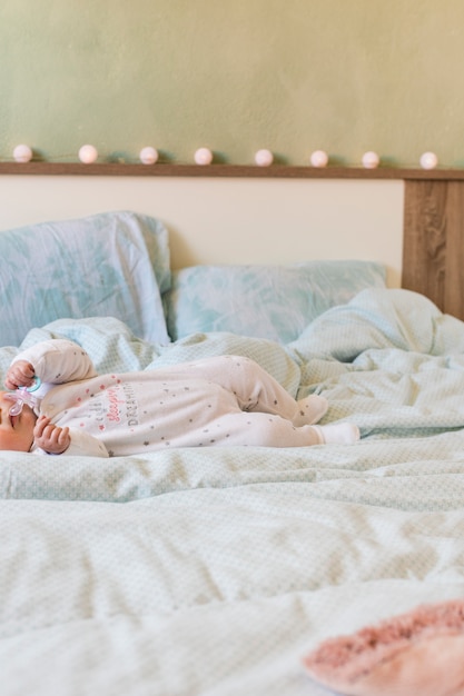 Little baby lying on bed