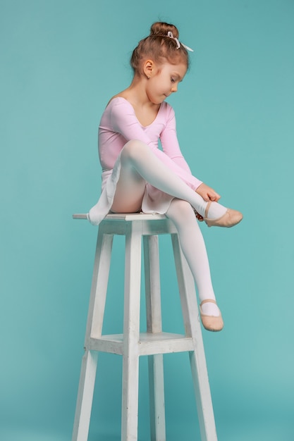 The little balerina dancer on blue background