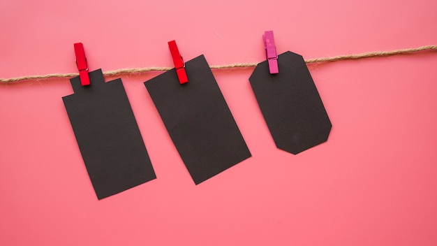 Free photo little black paper tallies hanging on thread