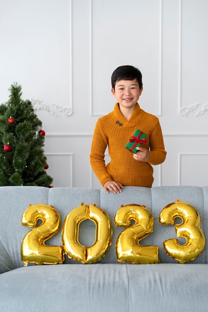 Free photo little boy celebrating new years eve at home