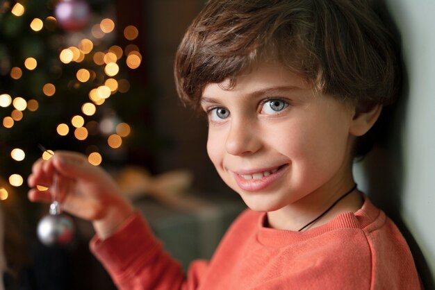 Little boy decorating the christmas tree