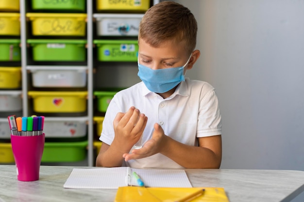 Little boy disinfecting his hands