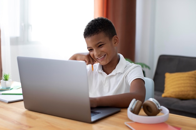 Little boy doing school online