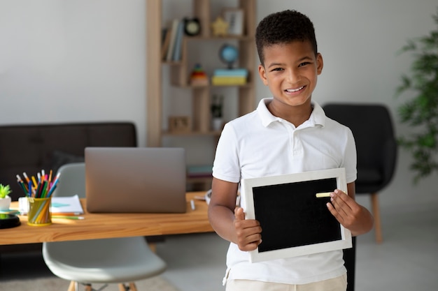 Little boy doing school online