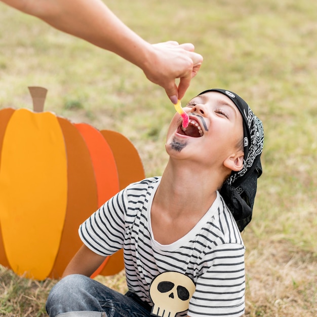 Free photo little boy eating jelly