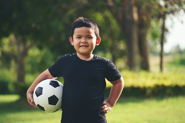 Little boy hand holding soccer football