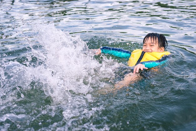 Little Boy Happy Swimming and Playing in the Lake Sport and Recreation Concept