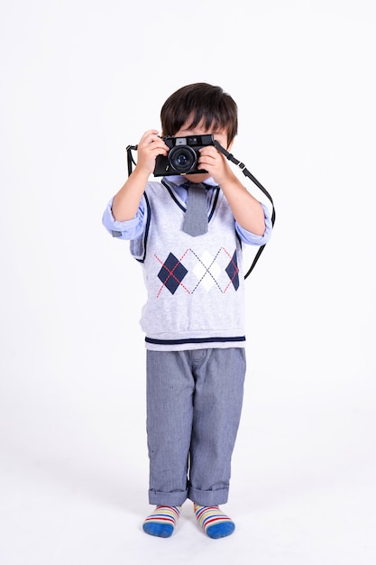 Little boy happy with camera on white