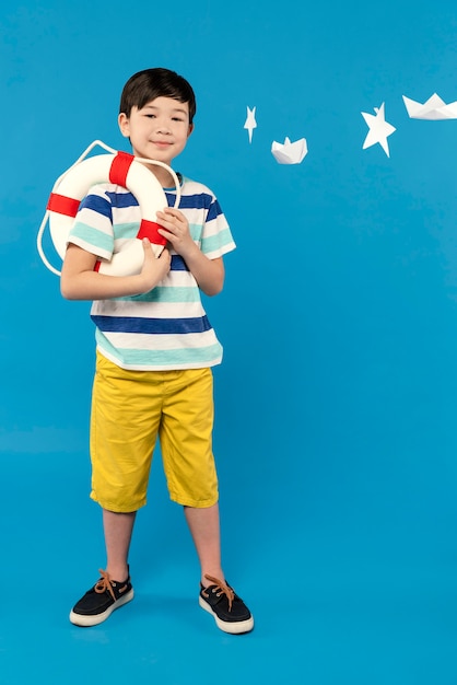 Little boy having fun in a summer setting studio