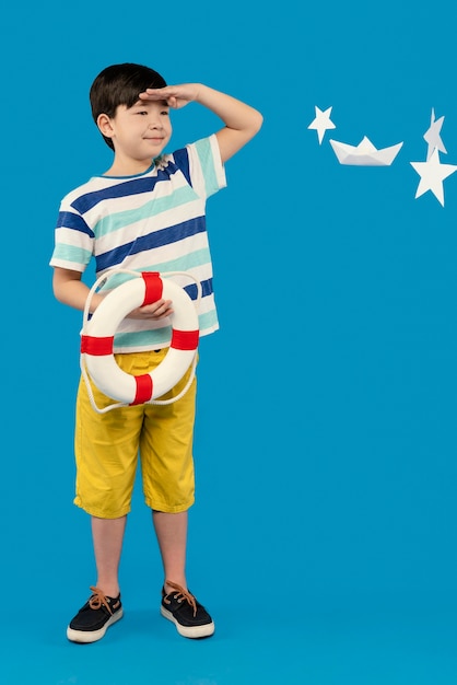 Little boy having fun in a summer setting studio