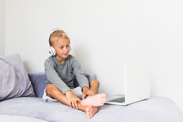 Free photo little boy having fun with laptop