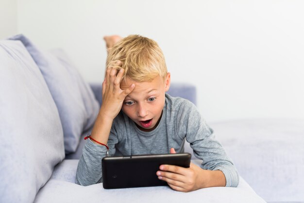 Little boy having fun with tablet