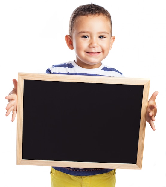 Little boy holding a blackboard