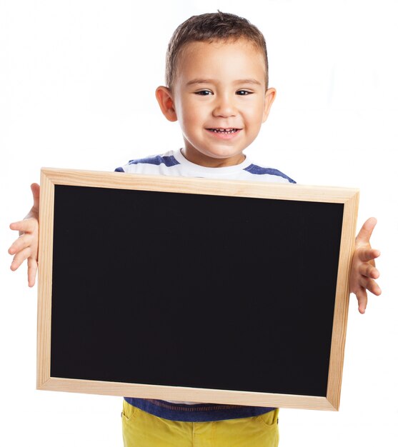 Little boy holding a blackboard