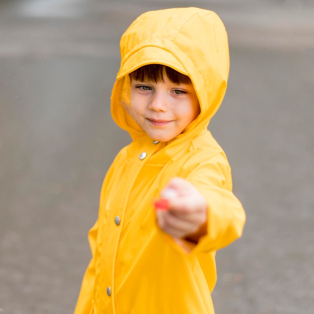 Free Photo little boy holding something unfocused in his hand