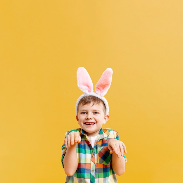 Little boy imitating rabbit