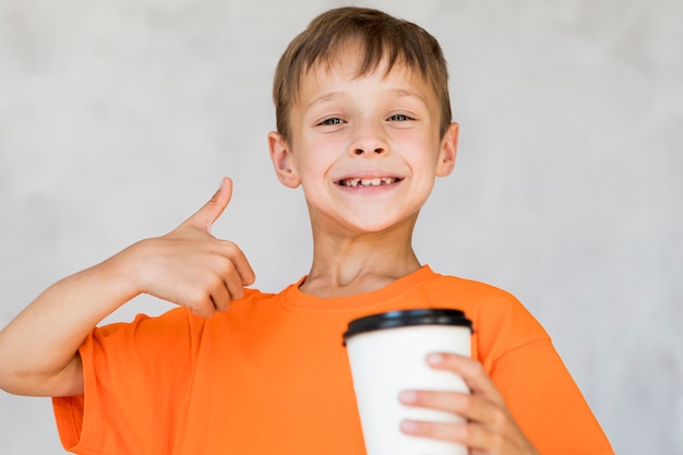 Little boy liking his drink