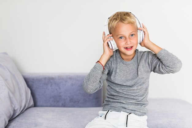 Little boy listening music at home