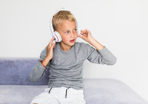 Little boy listening music at home