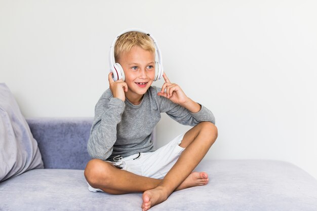 Little boy listening music at home