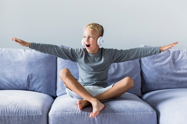 Little boy listening music at home