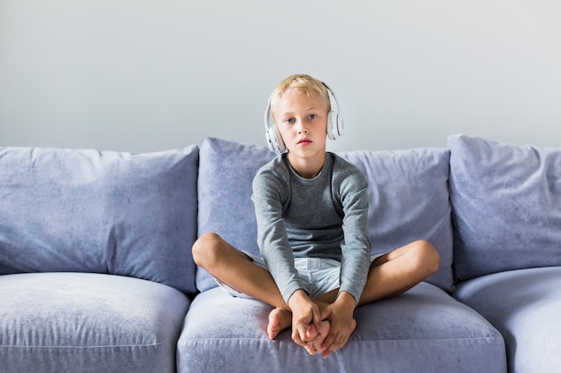 Little boy listening music at home