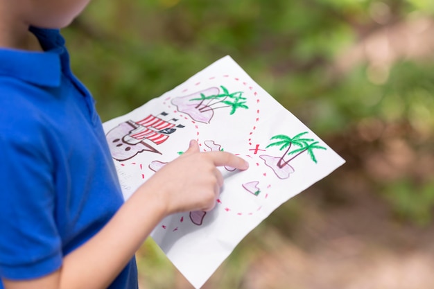 Free Photo little boy participating in a treasure hunt