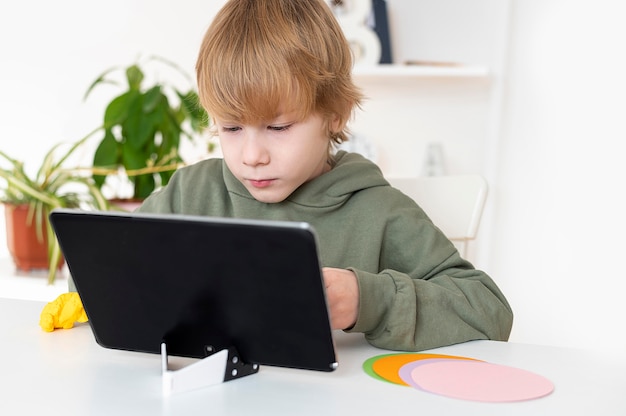 Little boy playing on the tablet