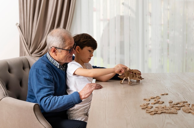 Little boy playing with his grandfather