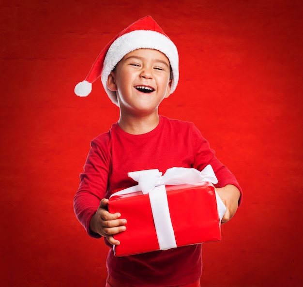 Little boy showing his present with a big smile