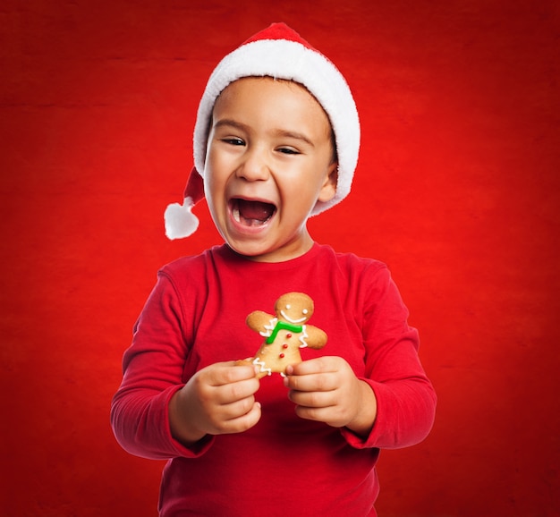 Little boy smiling before eating his cookie