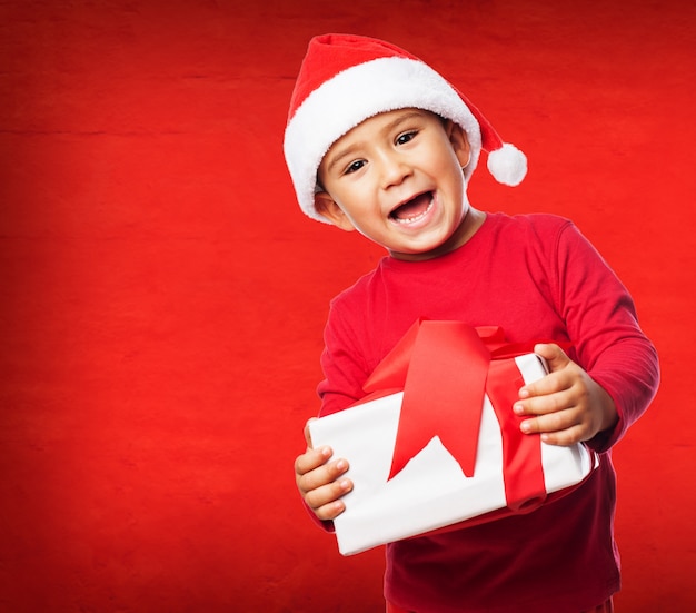 Free Photo little boy smiling with his new present