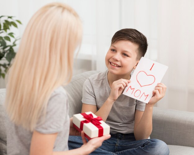 Little boy surprising mom