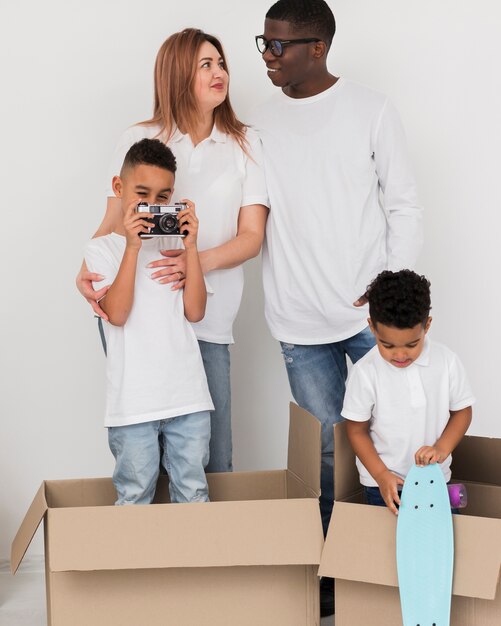 Little boy taking photos next to his family