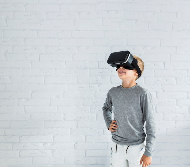 Free photo little boy using virtual reality glasses