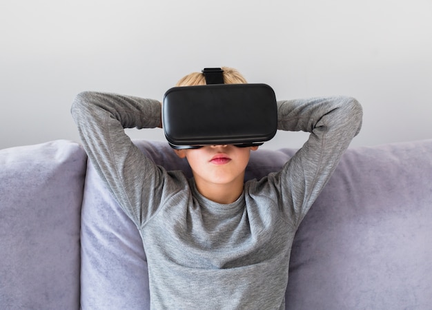 Little boy using virtual reality glasses