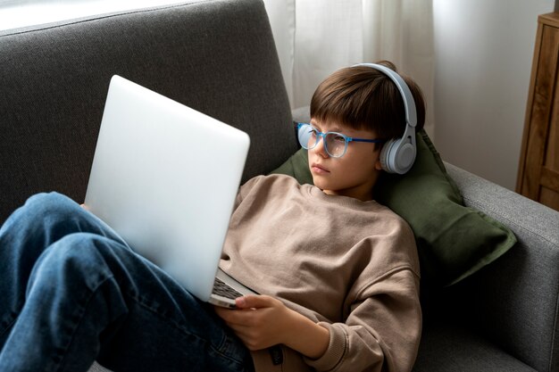 Little boy watching films on the laptop