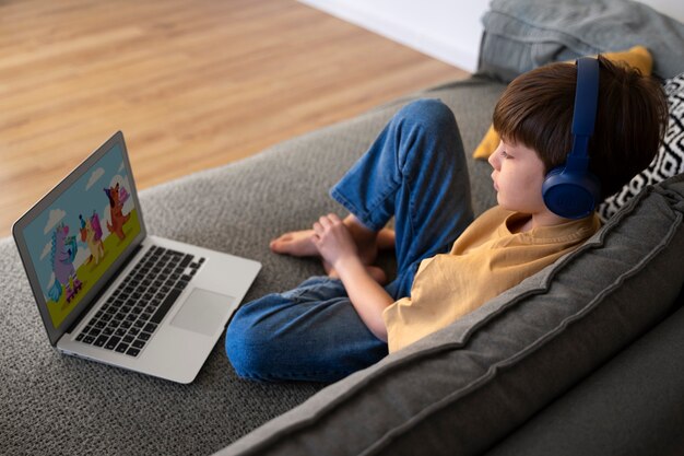 Little boy watching films on the laptop