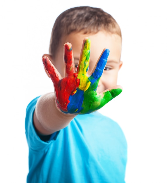 Free Photo little boy with a hand full of paint covering his face