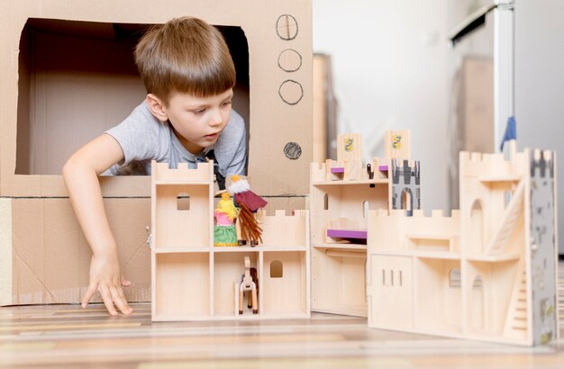 Little boy with wooden castle