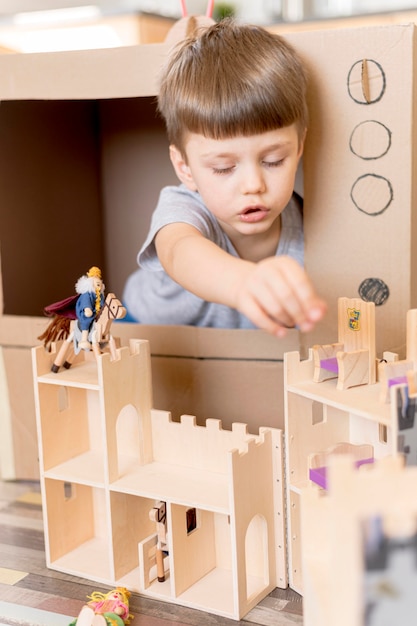 Little boy with wooden castle