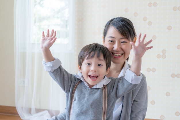 Little boy and young mother smiling and playing together