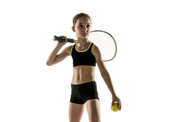 Little caucasian girl playing tennis isolated on white wall