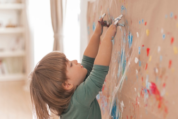 Little child painting like an artist