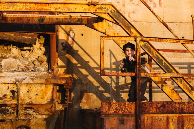 Little child with binoculars at steps