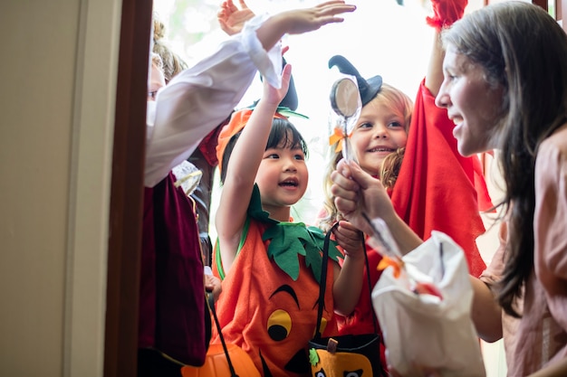 Free photo little children trick or treating on halloween