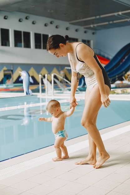 Free photo little cute baby boy. mother with son. family playing by the water