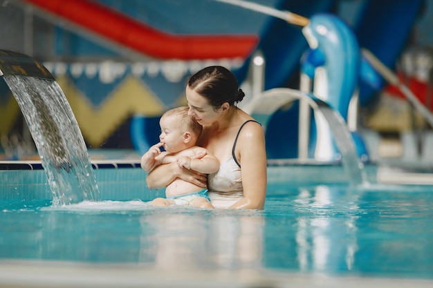 Little cute baby boy. Mother with son. Family playing in a water