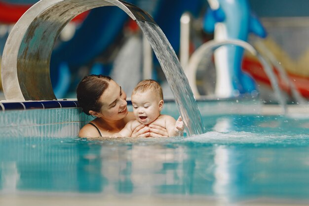 Little cute baby boy. Mother with son. Family playing in a water